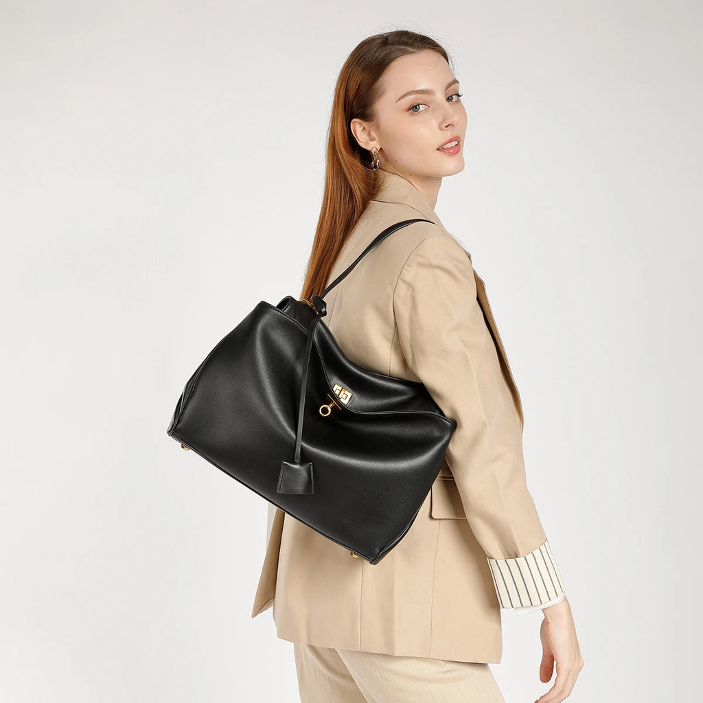 Woman wearing a black leather backpack on a white background, Designer Underarm Handbag.